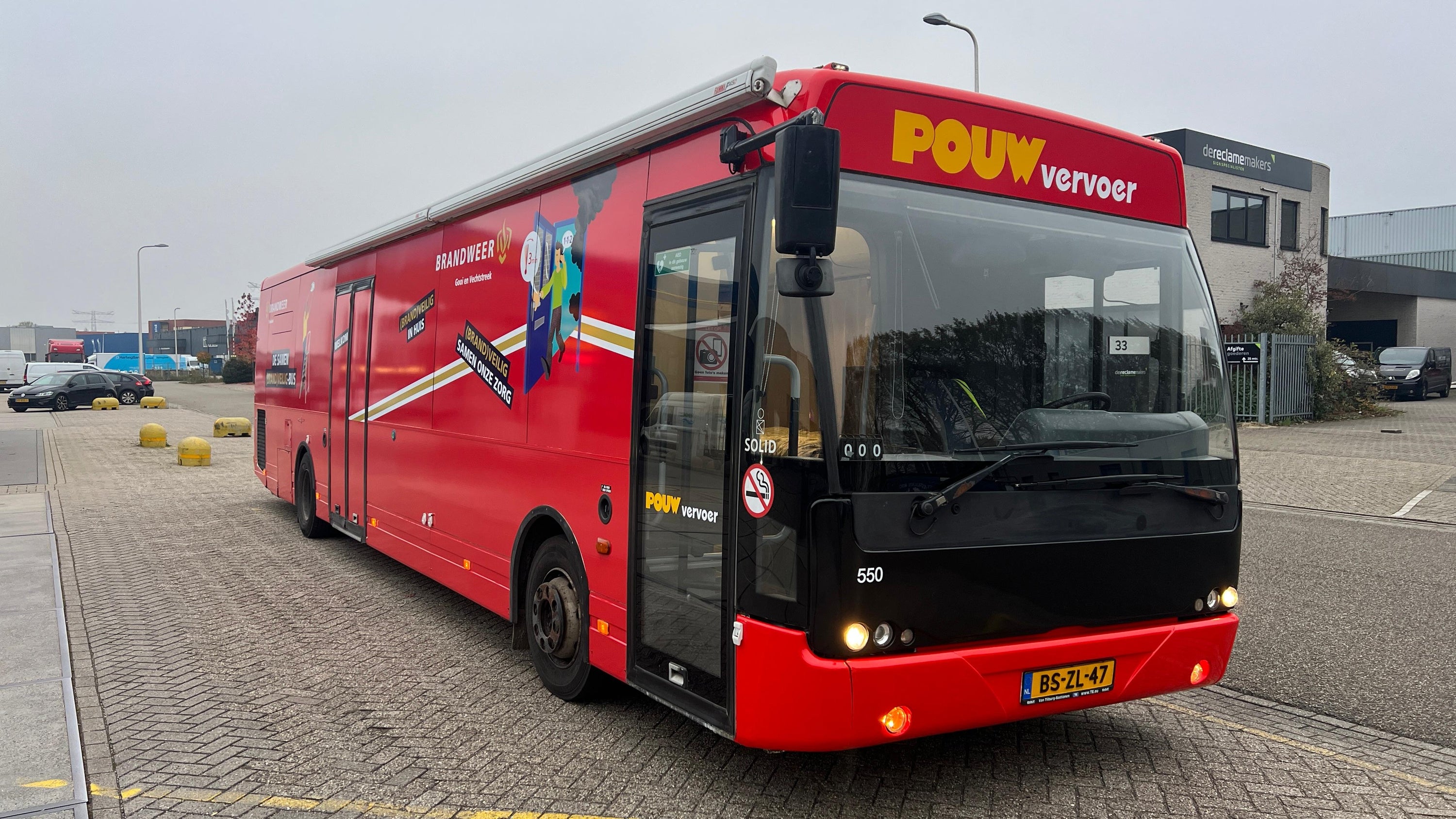 Een rode VDL Ambassador  in de uitvoering  Brandweerbus - Pouw.